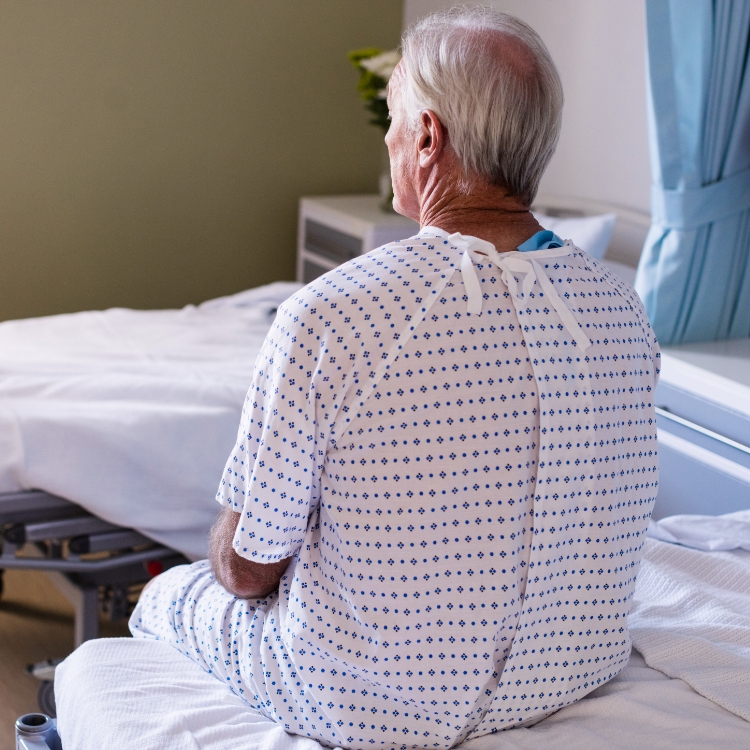 thoughtful-male-senior-patient-sitting-ward